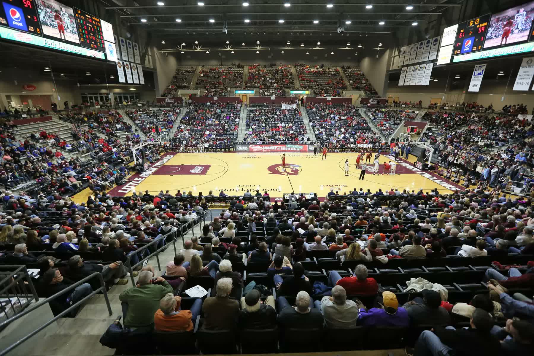 The Jack Stephens Center arena at UA Little Rock, packed with thousands of fans around the maroon Trojans court